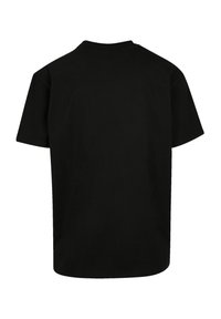 Black cotton t-shirt, short sleeves, round neckline, boxy shape, smooth texture, no visible logos or patterns on the back.