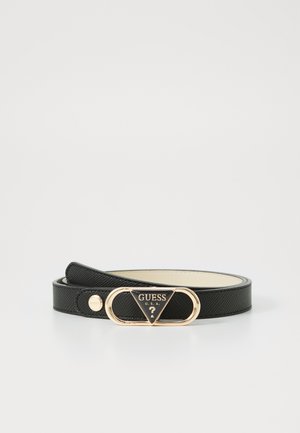 Black textured belt with a gold-tone oval buckle featuring a black triangle logo and "GUESS U.S.A." embossed. Smooth inner lining.