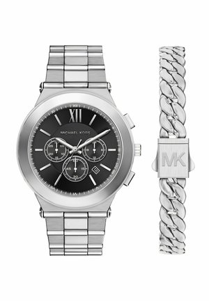 Silver Michael Kors watch with black chronograph dial and Roman numeral XII, alongside matching silver chain-link bracelet with MK clasp.