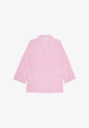 Lichtroze pyjamabot met witte cirkelvormige stippen, met een ingeknipt kraagje, lange mouwen, twee voorzakken en witte bies langs de randen.