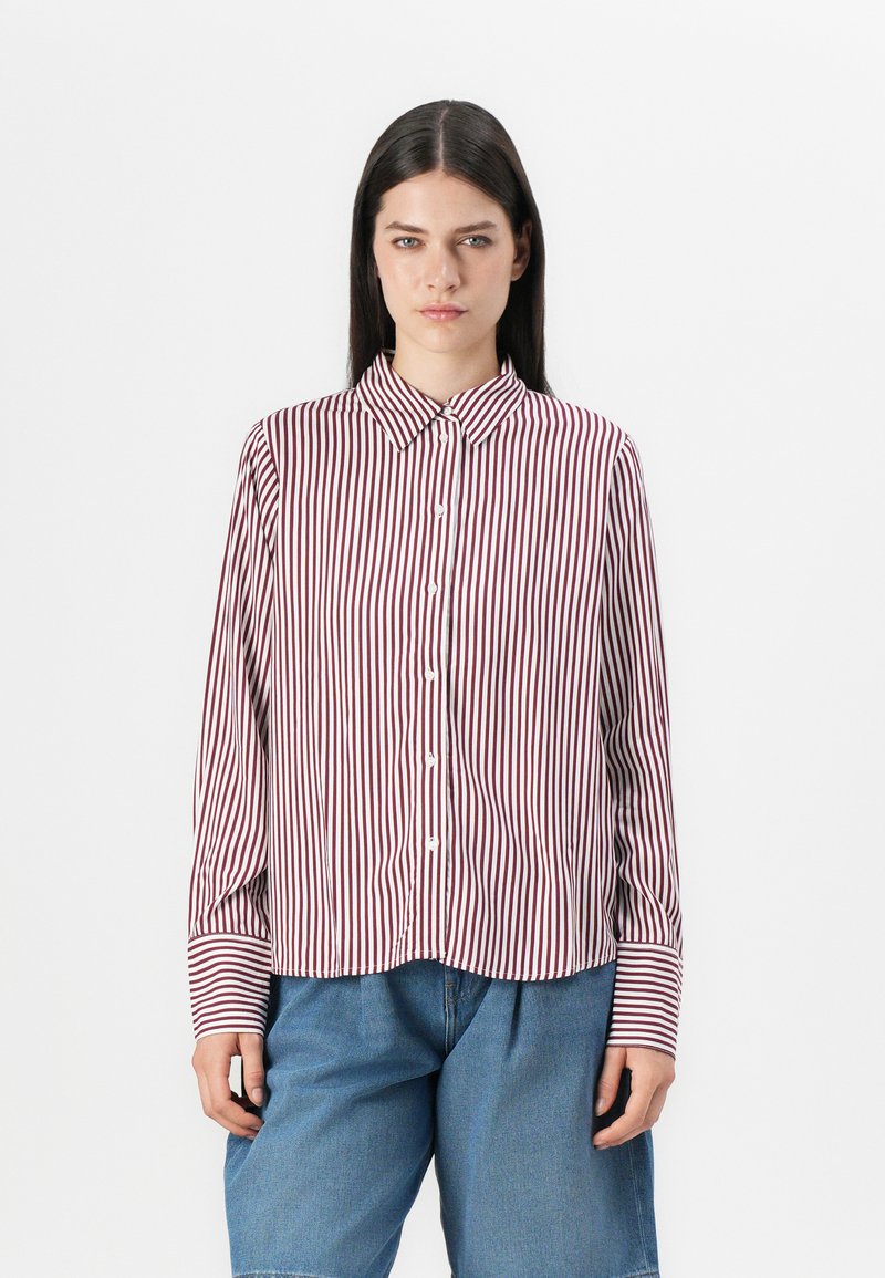 Striped button-up shirt in burgundy and white, featuring long sleeves, a classic collar, and a curved hem. Made from lightweight fabric.