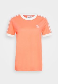 Coral cotton t-shirt with white ribbed crew neck and sleeve cuffs, featuring white side stripes and a small white logo on the chest.