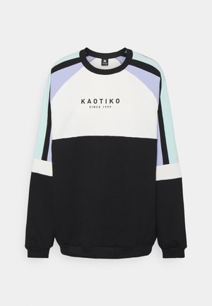 Sudadera de cuello redondo con paneles en negro, blanco, verde menta y lavanda. Presenta el logo "KAOTIKO" y puños acanalados en contraste.