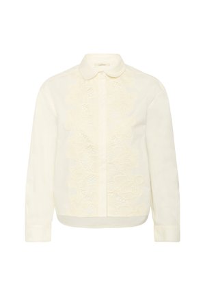 Blouse crème avec un col classique, fermeture à boutons sur le devant et un délicat détail en dentelle le long du panneau central. Manches longues avec poignets à boutons.