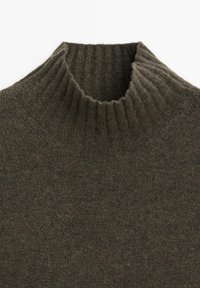 Dark green wool turtleneck sweater featuring a ribbed neckline and textured knit, offering a warm and cozy design.