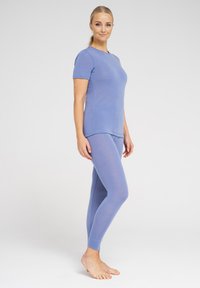 Light blue short-sleeve top and matching leggings made of soft, stretchy fabric. The outfit has a fitted design and smooth texture.