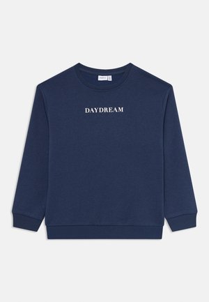 Sweat-shirt col rond bleu marine avec des poignets et un ourlet côtelés, arborant le mot "DAYDREAM" en blanc, centré sur la poitrine.
