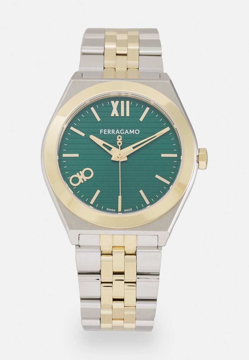 Green dial watch with gold and silver stainless steel bracelet. Octagonal case, gold accents, horizontal pattern on the dial, and prominent numeral XII.