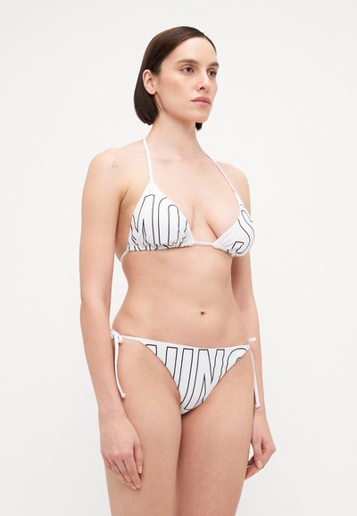 White bikini with bold black text. Triangle top with adjustable straps; bottom features tie sides. Smooth fabric, minimalistic design.
