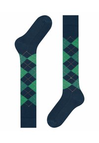 Calzini blu scuro con un motivo argyle verde e nero, caratterizzati da forme a rombo. Presentano piccoli dettagli arancioni lungo i bordi dei rombi.