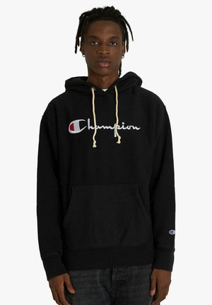 Felpa con cappuccio nera in cotone con tasca frontale, logo "Champion" ricamato in bianco e cordini beige. Polsini a costine, tessuto morbido.