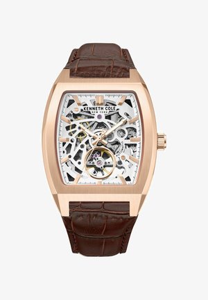 Vierkante automatische horloge met een roségouden kast, een transparante wijzerplaat die ingewikkelde mechanica toont, en een bruine leren band met krokodillenmotief.