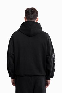 Black hooded sweatshirt with a relaxed fit, featuring a kangaroo pocket and decorative graphics on the right sleeve. Soft texture.