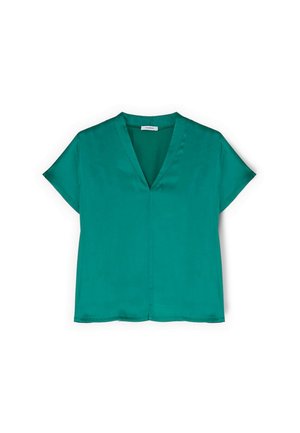 Zelená krátká halenka s výstřihem do V a hladkou, hedvábnou tkaninou položená na bílém pozadí.