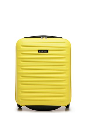 Yellow hard-shell suitcase with a textured surface, ribbed design, black accents, top handle, and zip closure. Brand logo displayed prominently.