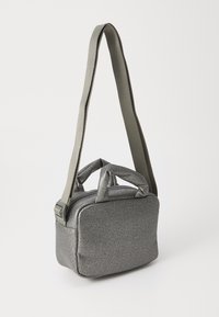 Gray fabric crossbody bag with a rectangular shape, dual short handles, and a long adjustable strap. Textured surface, zippered top closure.