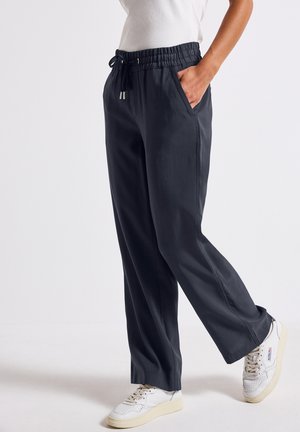 Black, lightweight, loose-fitting pants with an elastic waist and drawstring. Features two side pockets and a smooth texture.