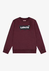 Felpa bordeaux con polsini e fondo a coste, caratterizzata da un grande logo nero di Levi's sul petto e un tessuto morbido e testurizzato.