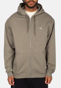 Gray zip-up hoodie with a drawstring hood, front pockets, and a small white logo on the left chest. Smooth fabric texture with ribbed cuffs.