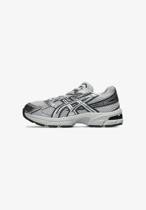 Grijze en witte atletische hardloopschoen met zwarte details en een mesh bovenwerk, zichtbaar vanaf de buitenkant op een witte achtergrond.