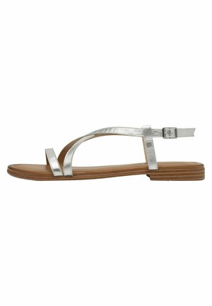 Silver metallic flat sandals with a minimalist design, featuring two crisscross straps and an adjustable ankle buckle on a brown sole.