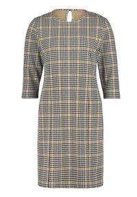 Svart och gul rutig klänning med rund halsringning och trekvartsärmar. Nyckelhål detaljer bak; rak skärning.