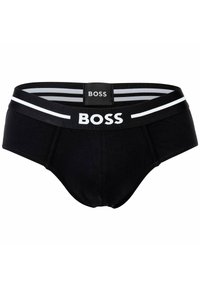 Slip da uomo neri con elastico in vita caratterizzato da strisce bianche e logo "BOSS" in lettere bianche in grassetto sull'etichetta frontale e posteriore.