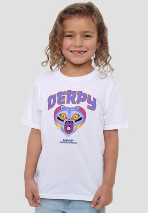 Smiling child with curly hair wearing a white T-shirt featuring a colorful cartoon cat face and the text "DERPY" and "KPOP Demon Hunters."