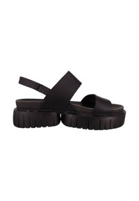 Sandalias de plataforma negras con suela gruesa, que cuentan con correas anchas y una banda ajustable en el tobillo para un ajuste seguro. Hechas de material sintético suave.