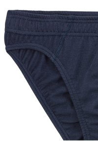 Marineblaue Baumwollunterhose mit elastischem Bund, ausgestattet mit Flachnähten und einer glatten Textur. Der Stoff ist weich und leicht dehnbar.