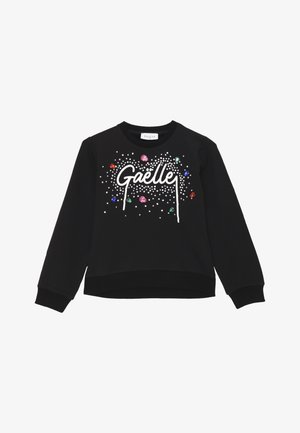 Felpa nera con la parola "Gaëlle" in bianco, decorata con gemme e perline colorate su uno sfondo a pois.
