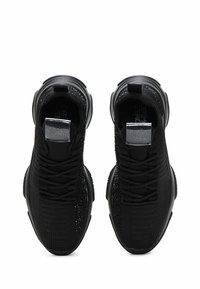 Black athletic shoes featuring a textured mesh upper, sleek round toe, tonal laces, and a reflective accent on the tongue.