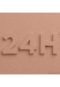 Surface texturée de couleur pêche avec des chiffres en relief "24H" dans une police sans empattement en gras. Le matériau semble mat avec une légère texture.