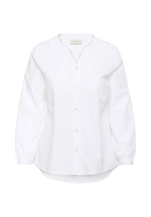 Chemise blanche à manches longues avec boutons, col rond et ourlet légèrement arrondi, présentée sur un fond blanc.