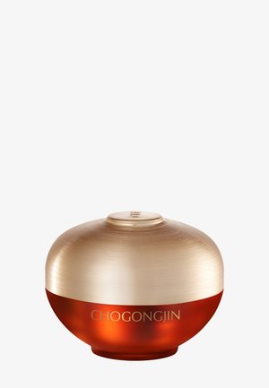 Pot cosmétique rond avec un couvercle doré mat et une base ambre translucide portant l'inscription "CHOGONGJIN" sur fond blanc.