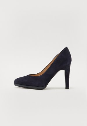 Navy blue suede high-heeled pump with a rounded toe, sleek design, and a smooth finish, featuring a slender stiletto heel and minimal detailing.