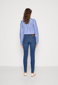 Wrangler High Skinny Jeans Para Mujer, Camellia, 29W / 32L