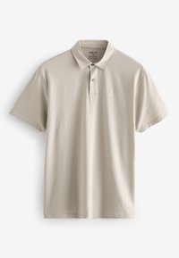 Polo beige in cotone, con colletto, maniche corte e un piccolo logo ricamato sul petto. Design semplice e classico.