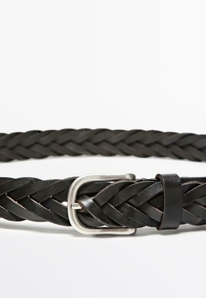 Black woven leather belt featuring a silver metallic buckle. The texture is intricate with a flat profile and an adjustable loop.