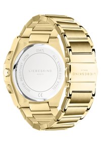 Goldfarbene Edelstahluhr mit achteckigem Gehäuse und Gliederarmband. Auf der Rückseite sind die eingravierte Marke und die Angaben zur Wasserbeständigkeit zu sehen.