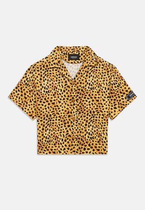 Kortermet, cropped skjorte i gult stoff med leopardmønster i svart og brune flekker, med knapper foran. Versace-merke inkludert.