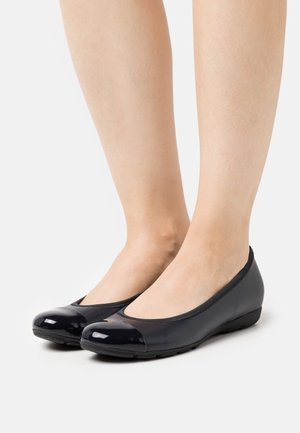 Laivastonsiniset ballerinakengät kiiltävällä patenttinilkalla, pehmeästä materiaalista, matalalla korolla ja joustavalla kumipohjalla, pyöreällä kärjellä.