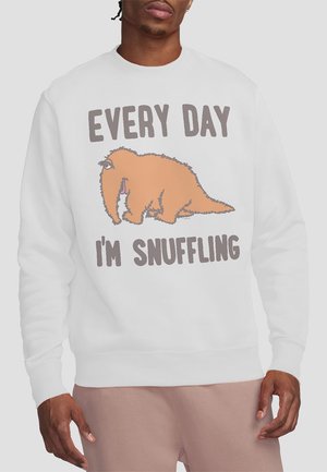White sweatshirt featuring an orange cartoon animal with text "EVERY DAY I'M SNUFFLING." Distinctive design with bold lettering and playful illustration.