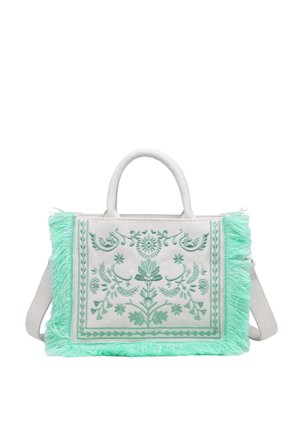 Sac à main en tissu blanc avec broderie florale vert menthe et bordure à franges, deux poignées et une bandoulière amovible.