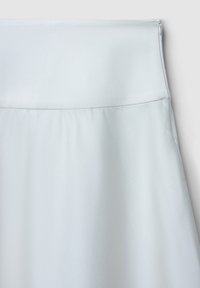 Jupe bleu clair présentant une texture lisse, une taille ajustée et une fermeture éclair latérale discrète, conçue avec une silhouette simple et épurée.