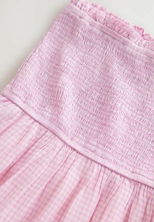 Pink shirred dress featuring a textured bodice and gathered skirt in a gingham pattern. Elastic ruffle trim along the neckline.