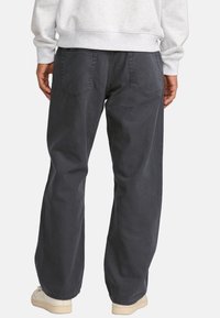 Dark gray cotton pants with a relaxed fit. Features two back pockets, a smooth texture, and a straight-leg design.