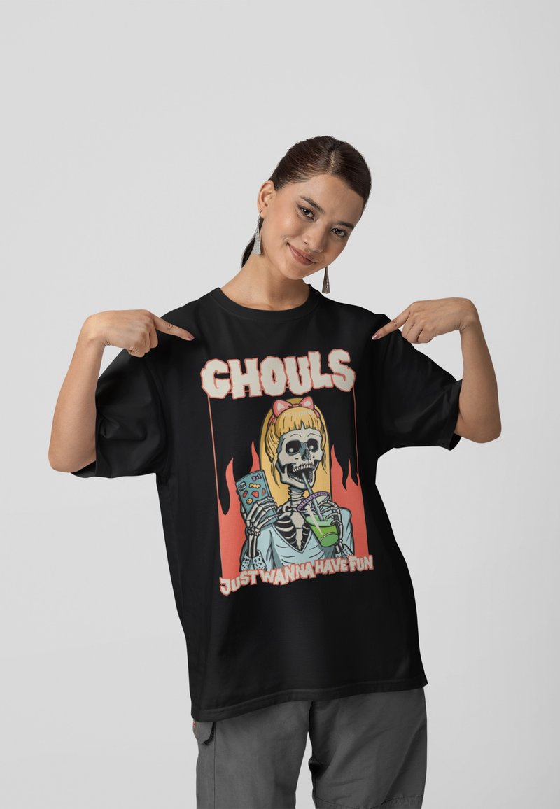 Black oversized T-shirt featuring a colorful graphic of a skeletal figure holding a drink and popcorn, with the text "GHOULS JUST WANNA HAVE FUN."