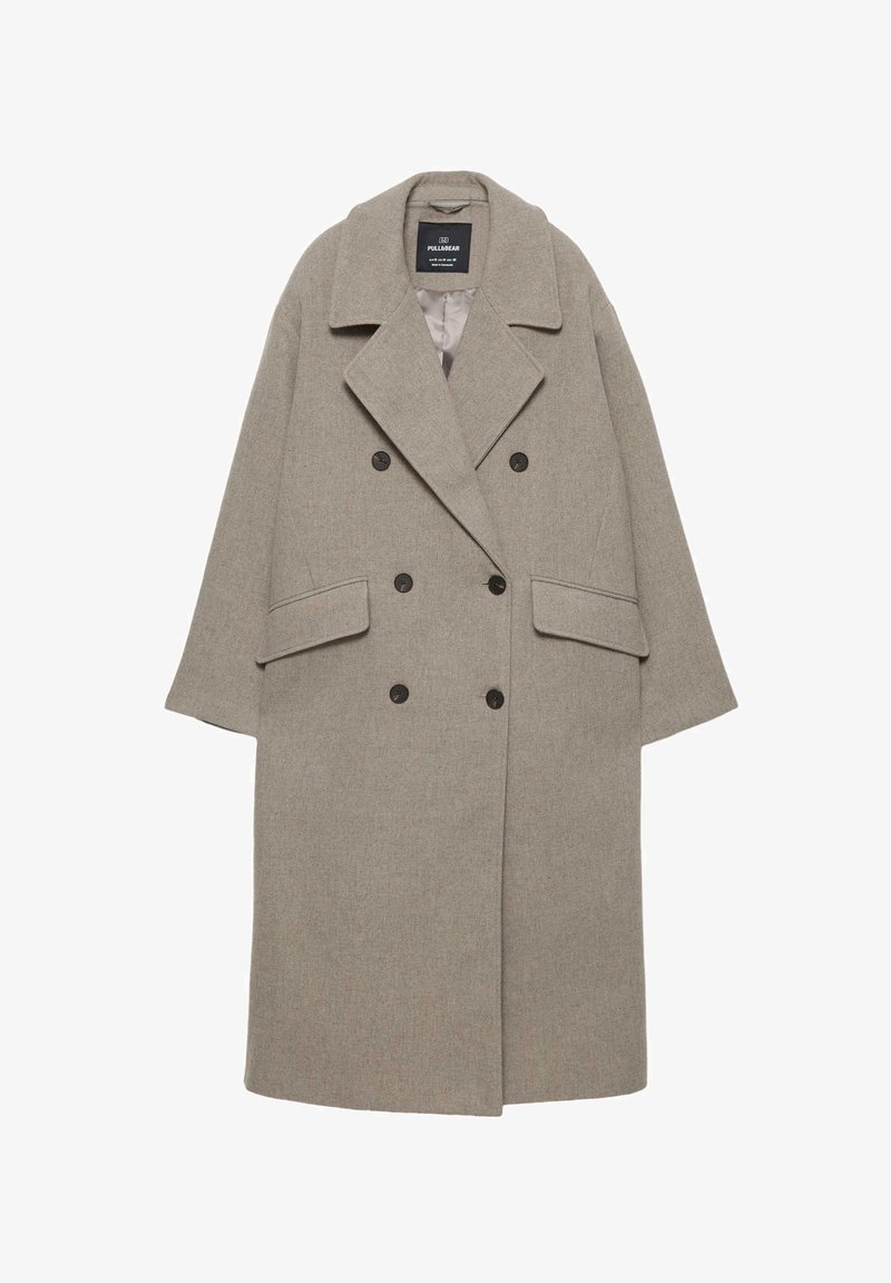 Manteau gris à double boutonnage en mélange de laine, avec de grands revers, deux poches avant et six boutons noirs sur le devant.