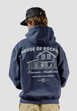 Felpa navy con una grafica bianca raffigurante una casa e le parole: "HOUSE OF POCKETS," "Leisure Aesthetics," e "MEDIOCRE SINCE FOREVER."